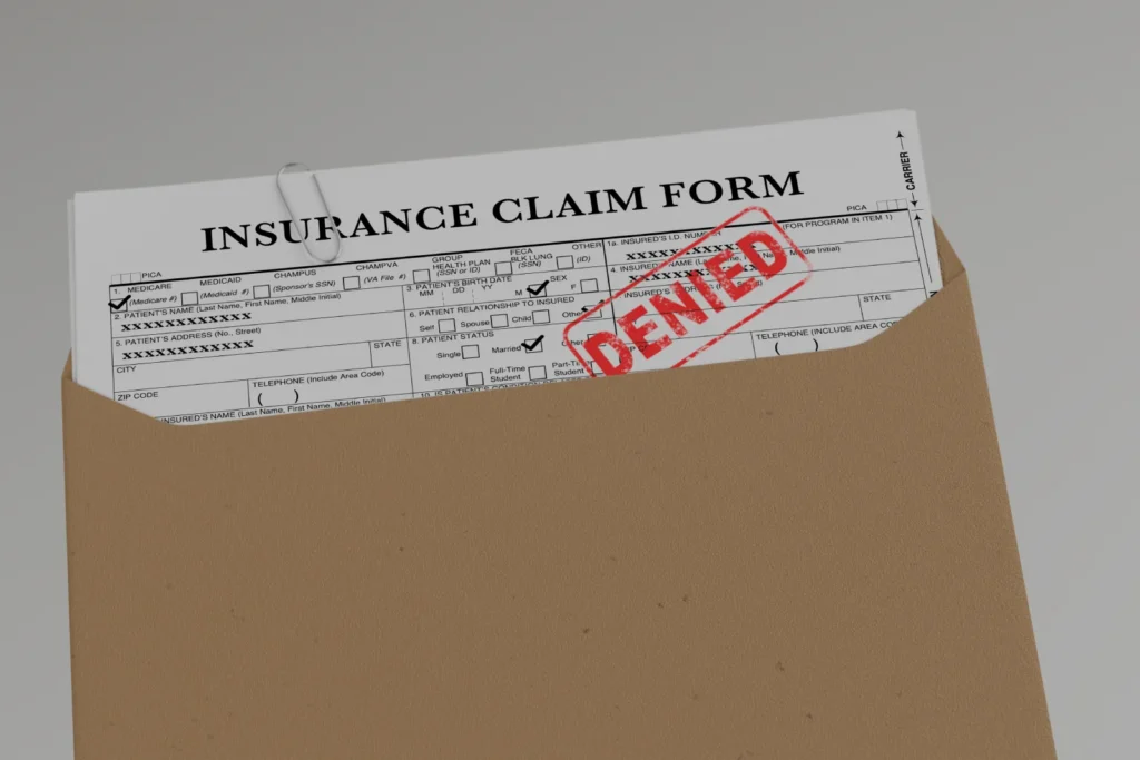 Insurance claim form stamped denied in an envelope showing what a health insurance claim was denied looks like