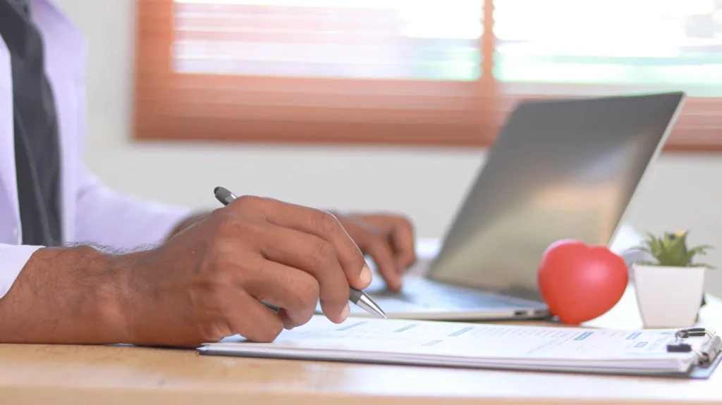Person reviewing health insurance documents to understand deductible copay and out-of-pocket maximum